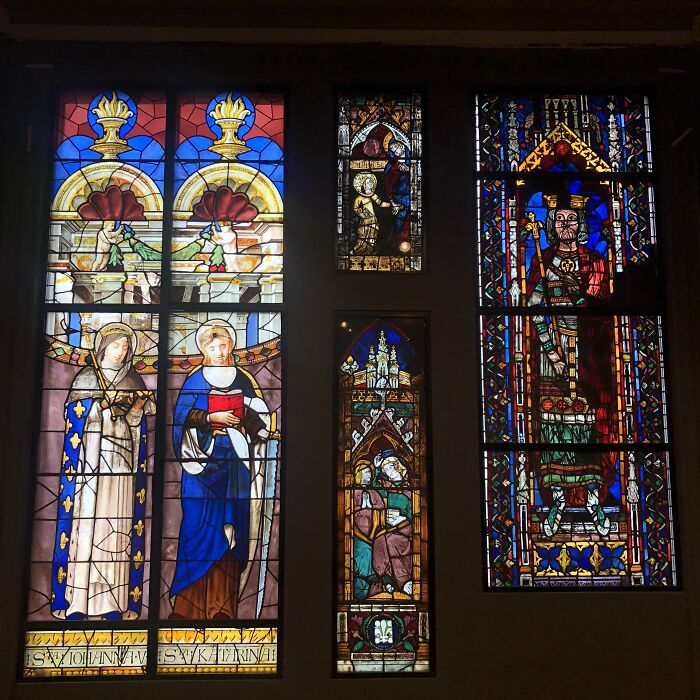 Collection of colorful stained-glass windows with religious figures and symbols Collection of colorful stained-glass windows with religious figures and symbols