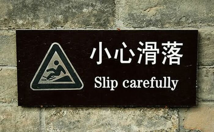 Sign showing a funny translation fail that reads Slip carefully.