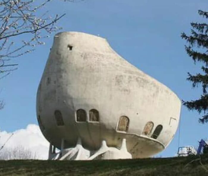 Odd rounded concrete strange building resembling a giant pot on hill
