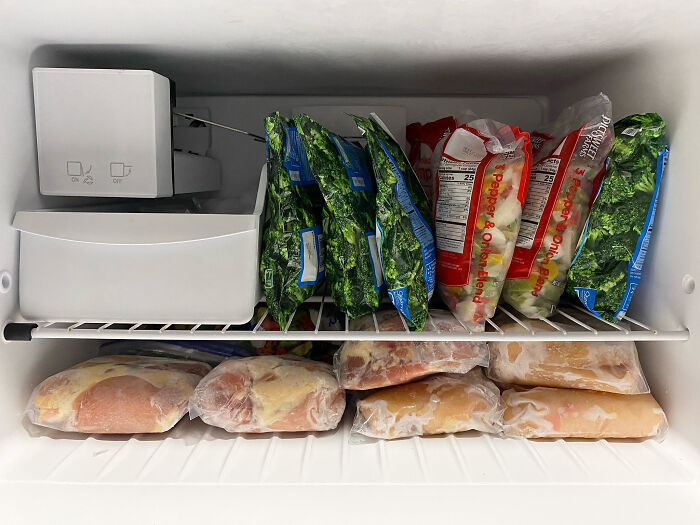 A freezer neatly filled with packaged frozen vegetables and meats, connected to domestic family feuds.
