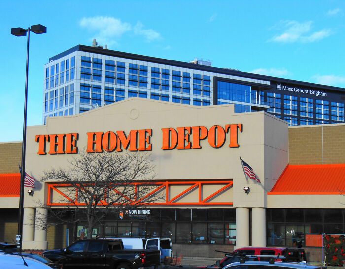 Home Depot store exterior with clear signage and parked cars Home Depot store exterior with clear signage and parked cars