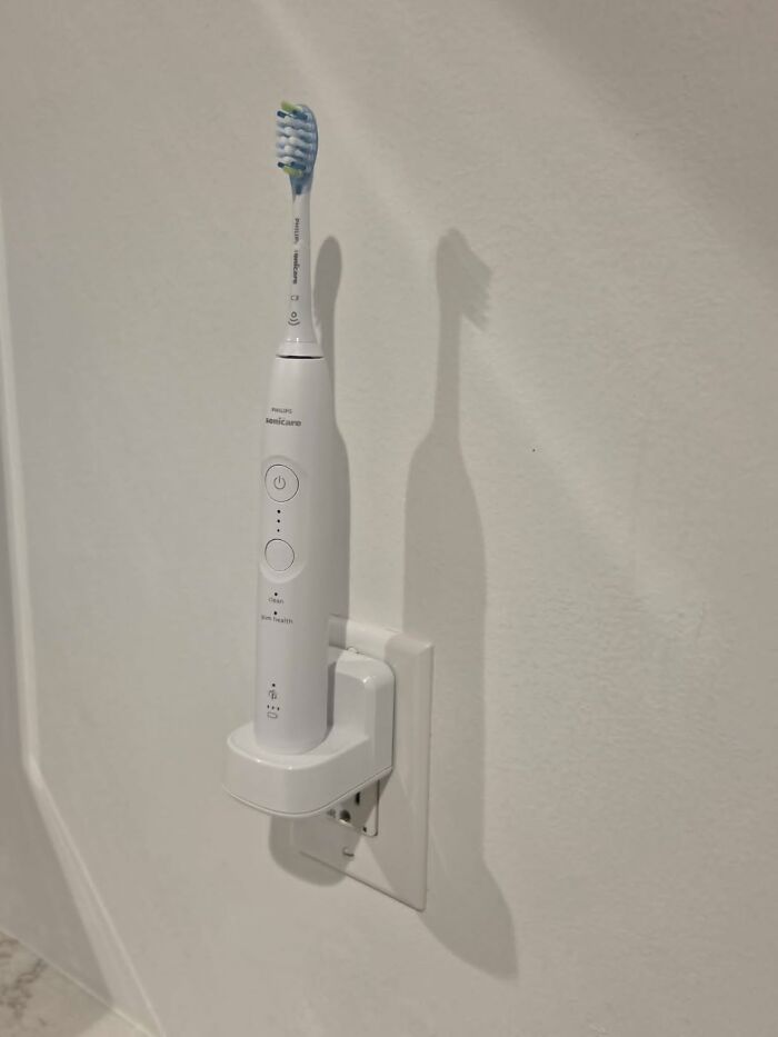An electric toothbrush charging on a wall mount, highlighting Big Deal Days.