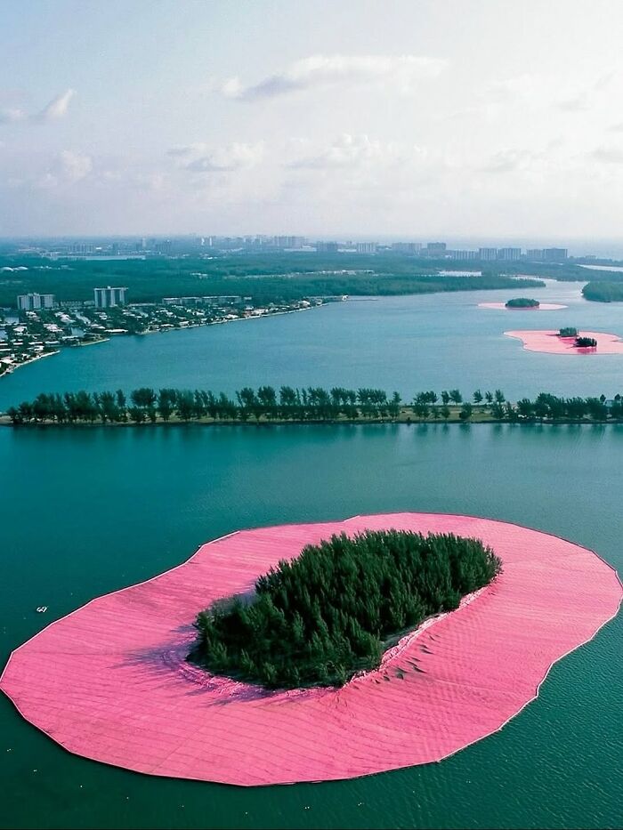 Aerial view of small islands surrounded by bright pink borders, making for entertaining pics in the water