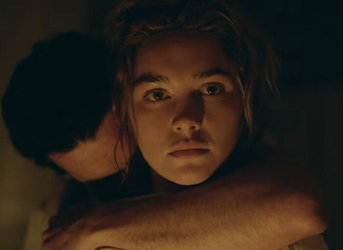 Close-up of Florence Pugh in a steamy scene with a man.