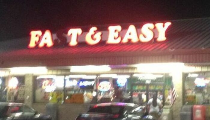 A glowing red storefront sign reading Fast and Easy in an advertising fails example
