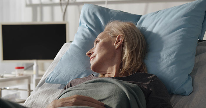 Elderly woman lying peacefully in hospital bed during end-of-life conversations Elderly woman lying peacefully in hospital bed during end-of-life conversations