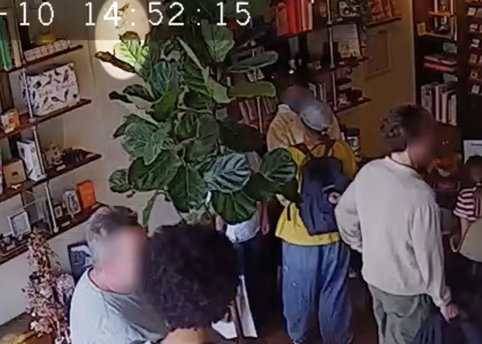 Close-up of customers inside store with plants and bookshelves visible