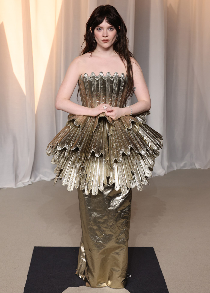Woman in metallic gold structured dress at Academy Museum Gala worst-dressed list