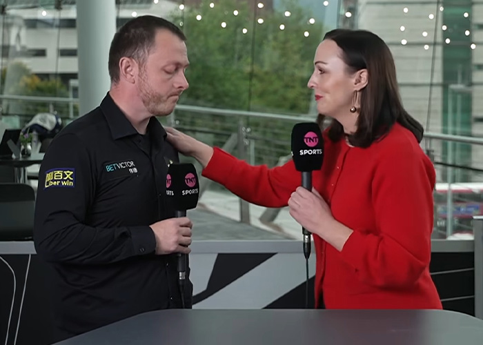 TNT Sports reporter Rachel Casey comforting snooker player Mark Allen during a mid-interview discussion.