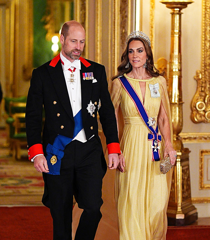 Prince William and Kate Middleton walking side-by-side in formal attire during a royal event.