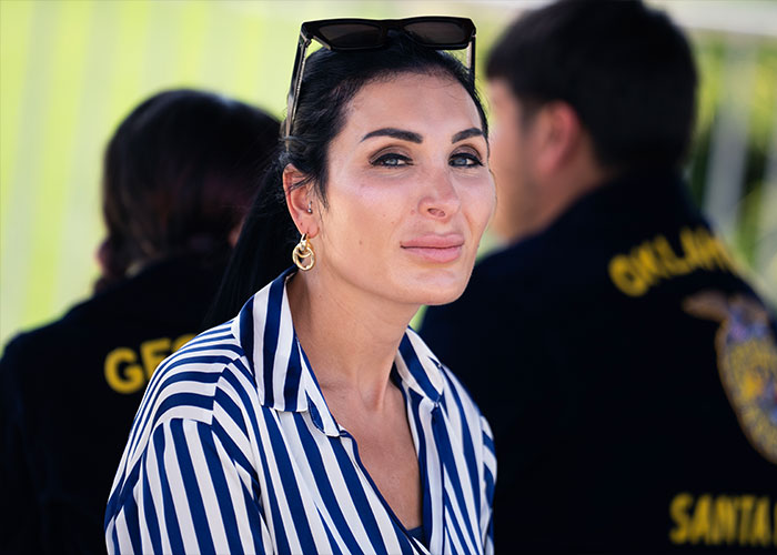 Laura Loomer smiling outdoors amidst discussions surrounding MAGA face trends in conservative circles. Laura Loomer smiling outdoors amidst discussions surrounding MAGA face trends in conservative circles.