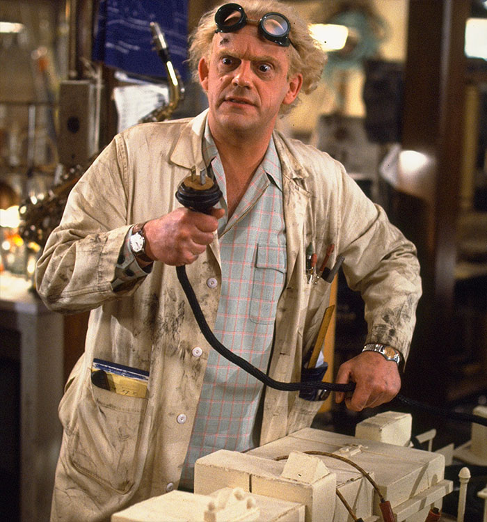Christopher Lloyd portraying Doc Brown holding a power cable. Christopher Lloyd portraying Doc Brown holding a power cable.