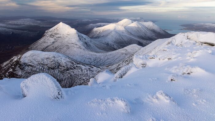 Snow-capped mountain peaks stretching to the horizon in Natural Landscape Photography Awards 2026 entry.