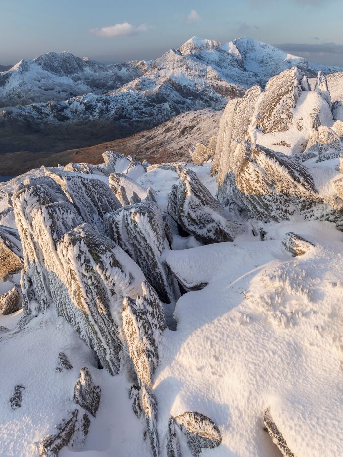 Frost-covered jagged rocks under clear sky, featured in Natural Landscape Photography Awards 2026.