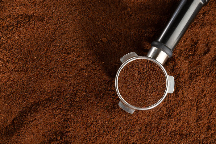 A espresso portafilter filled with coffee grounds, highlighting safety and emergency tips around the home.