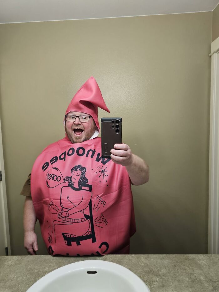 A man wearing a funny whoopee cushion outfit as a low-effort Halloween costume taking a selfie.