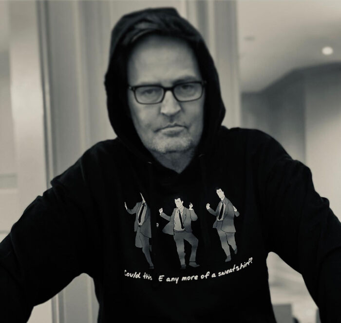 Matthew Perry wearing a hooded sweatshirt with a graphic inspired by his role in Friends.