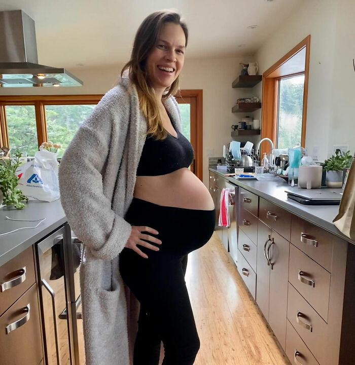 Hilary Swank's baby bump visible as she smiles in kitchen Hilary Swank's baby bump visible as she smiles in kitchen