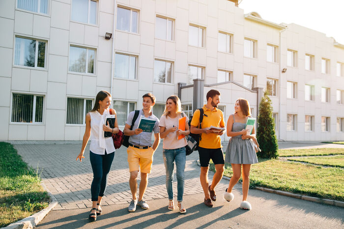 A group of young students walking together on campus, representing members in lesser-known cults.