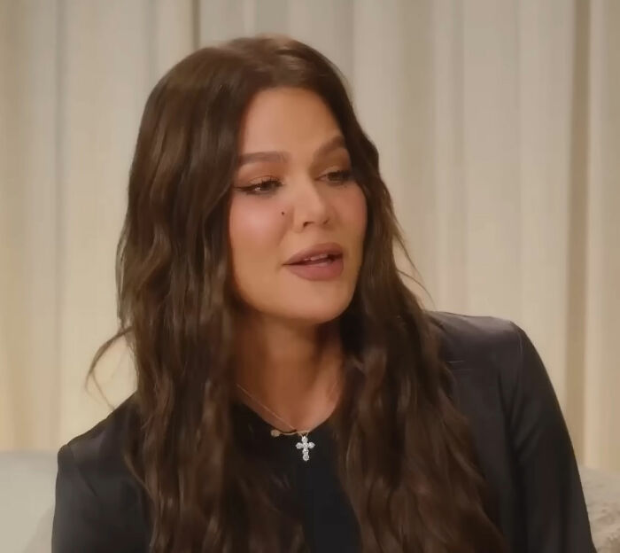 Woman with long wavy hair speaking in an interview Woman with long wavy hair speaking in an interview