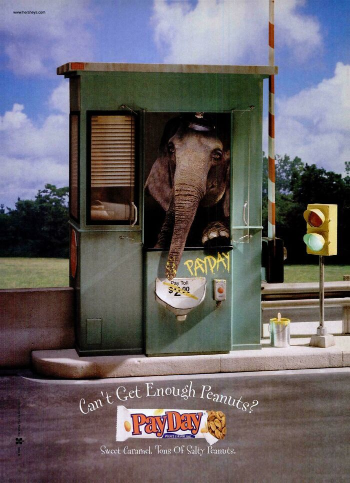 A PayDay candy bar advertisement with an elephant in a toll booth. Vintage products.
