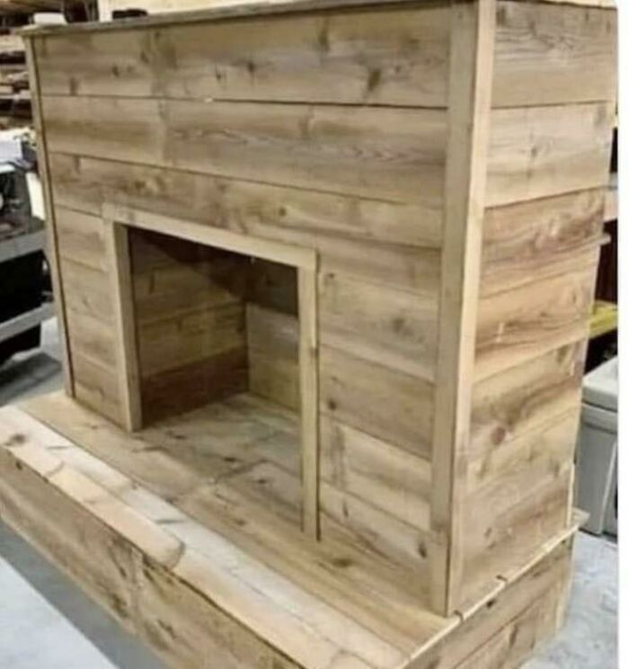 A DIY project of a rustic wooden fireplace mantel handcrafted from light brown timber planks.