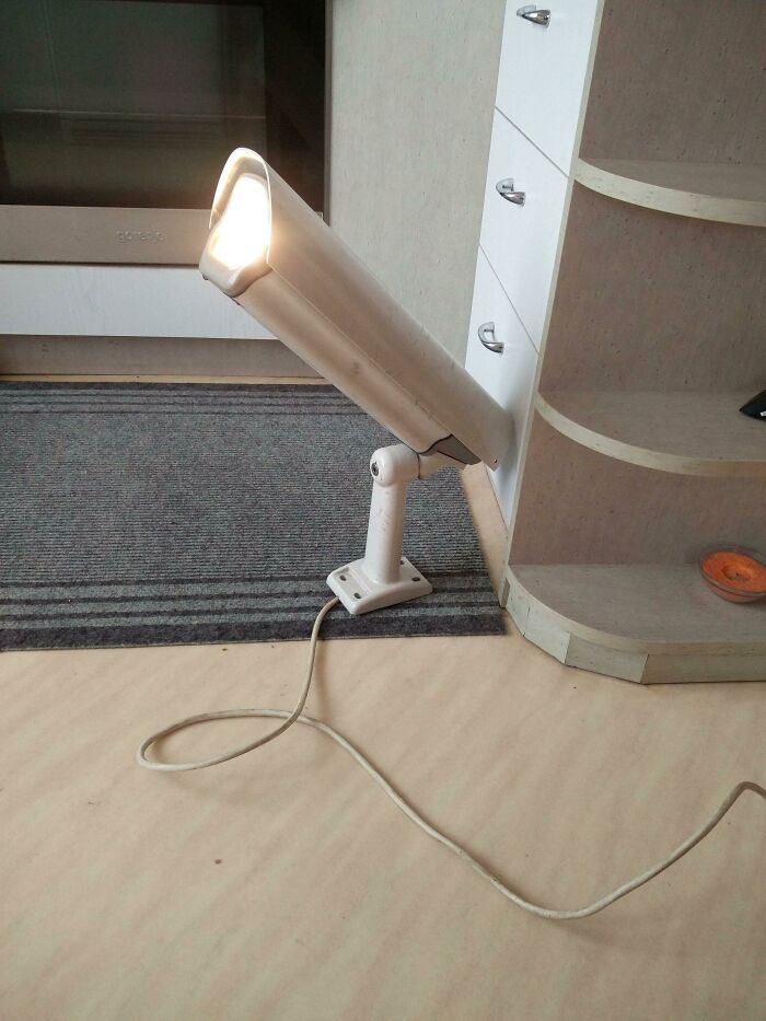 A creative DIY projects lamp shaped like a surveillance camera on the floor