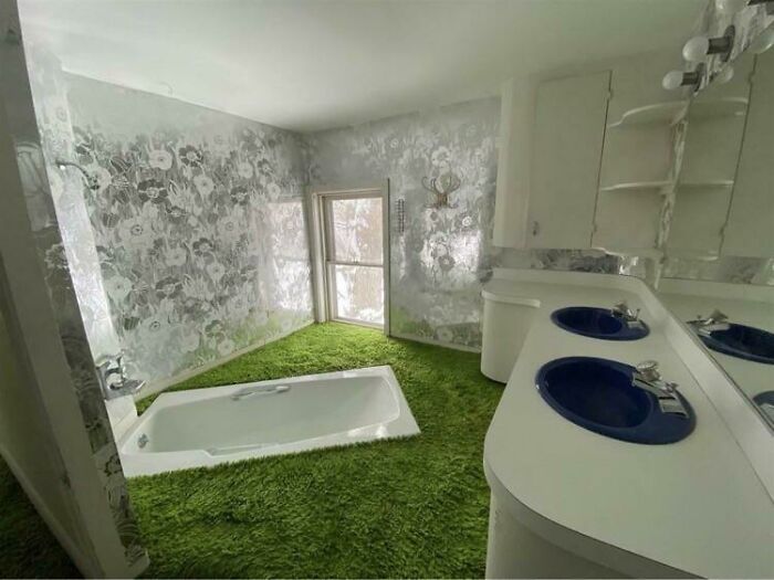 Quirky DIY Projects bathroom featuring a vibrant green s**g carpet floor surrounding a built-in white bathtub