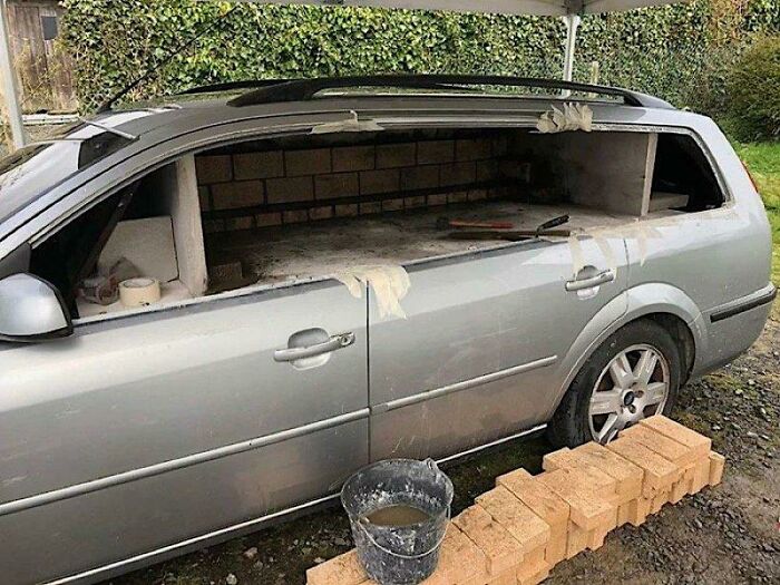 An unusual DIY project converting a car interior into a brick wood fired pizza oven