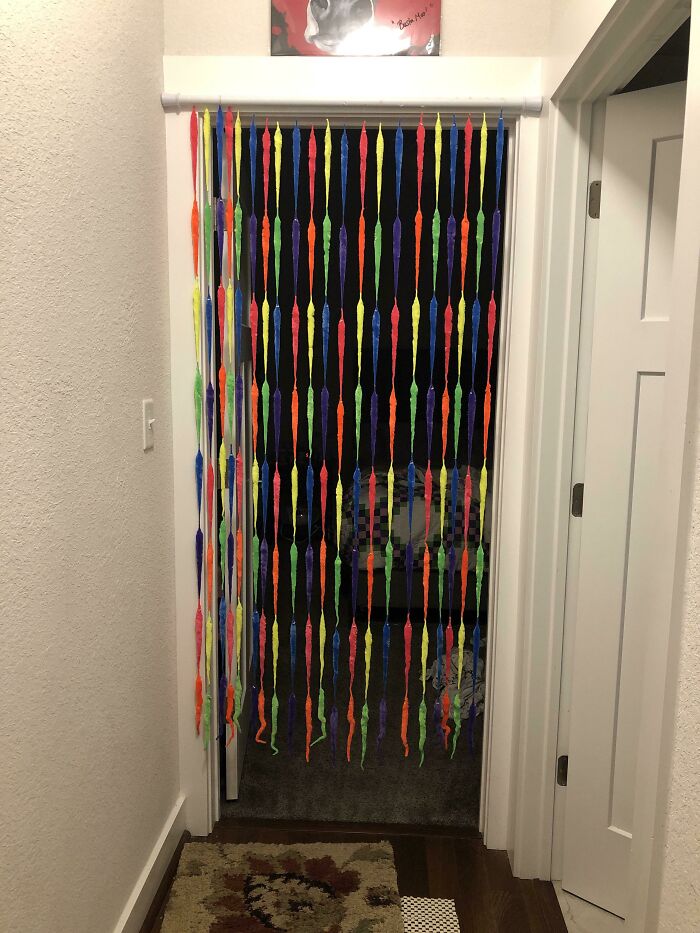Colorful DIY projects hanging as a doorway curtain made from bright plastic worms
