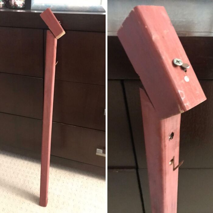 Close-up of a broken red wooden pole patched with a s***w, showcasing failed DIY projects.