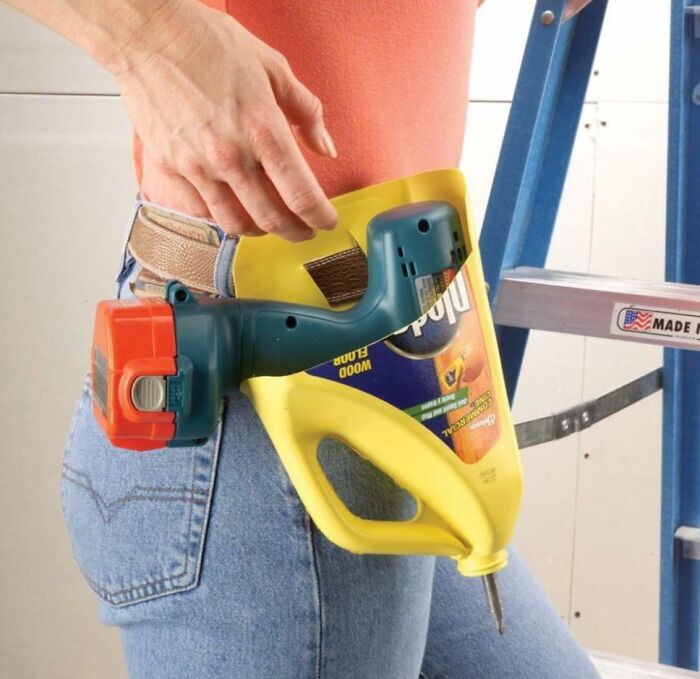 A DIY project drill holster crafted from a yellow plastic detergent bottle attached to a belt