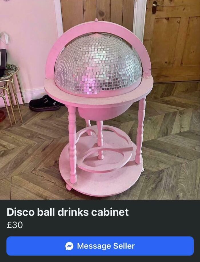 A pink painted DIY project bar globe turned into a glittering disco ball drinks cabinet on a wooden floor