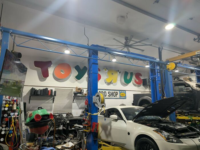Toys R Us sign mounted on garage wall, nostalgic images of childhood memories
