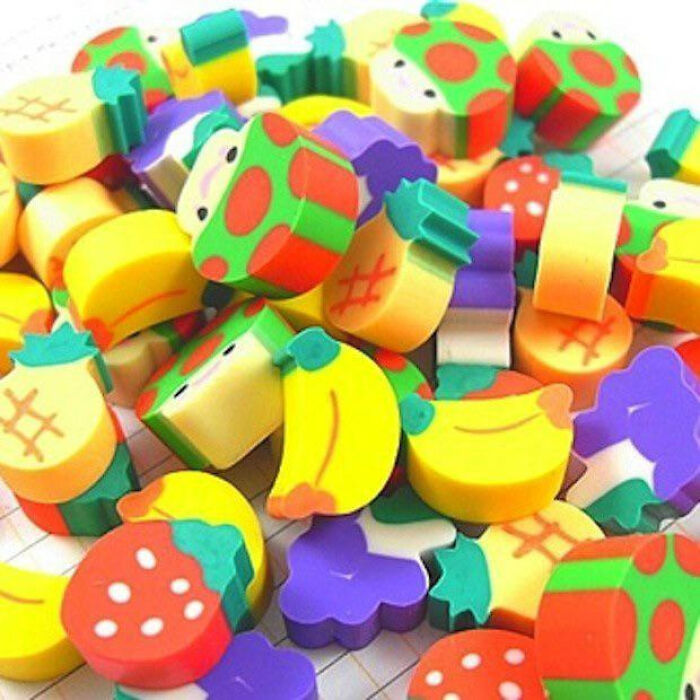 A pile of colorful, fruit-shaped novelty erasers, representing nostalgic images from the 90s