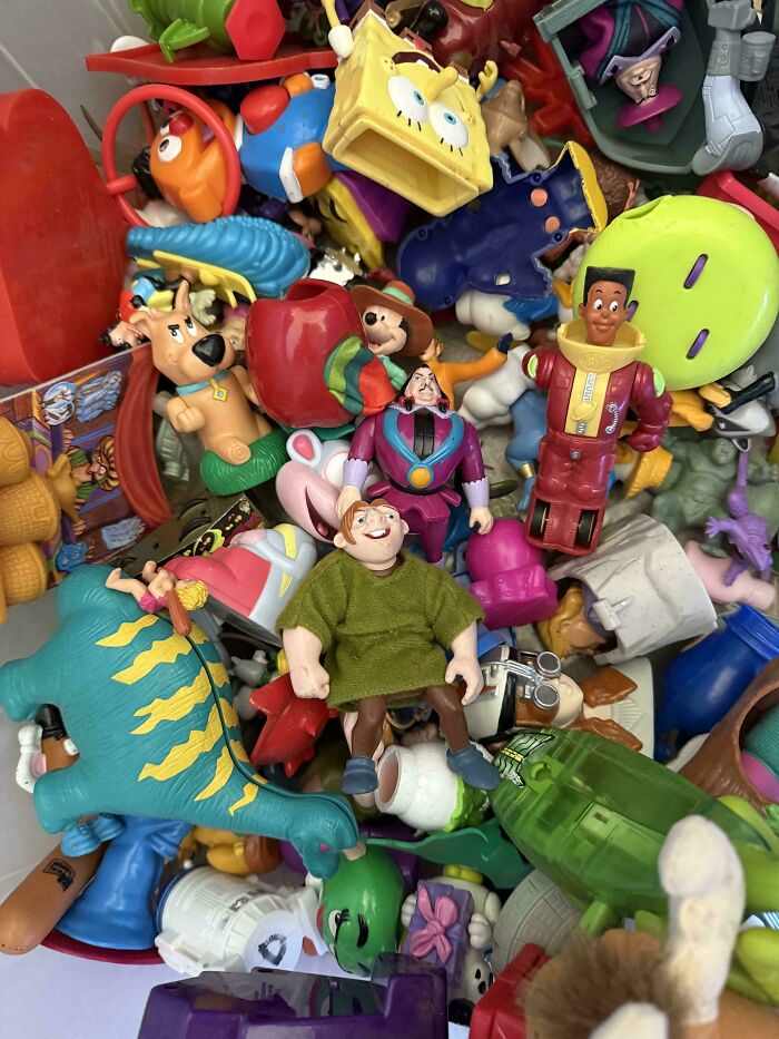 A pile of colorful plastic toy figures of various cartoon characters, a classic for 90s kids