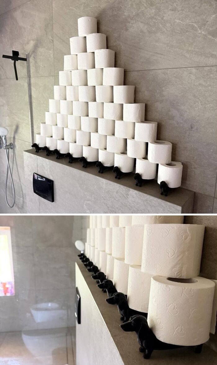 Innovative 3D prints of black dachshund dogs holding a pyramid of toilet paper rolls on a bathroom shelf.