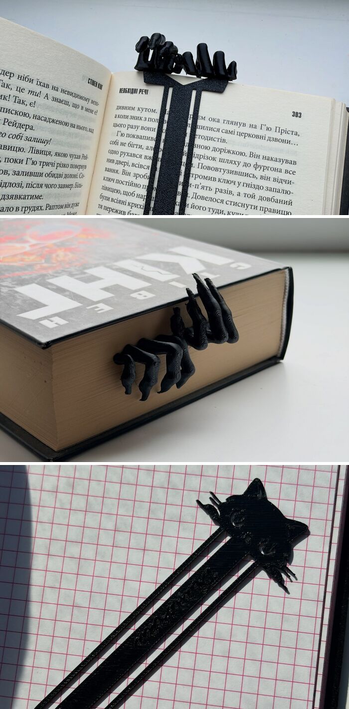 Three creative 3D prints bookmarks resembling creepy black hands and a cat face inside books.