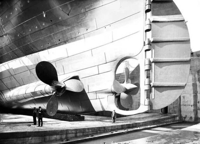 Titanic In Dry Dock. Here You Can See The Scale Of The Person Standing Next To One Of The Propellers. 1912