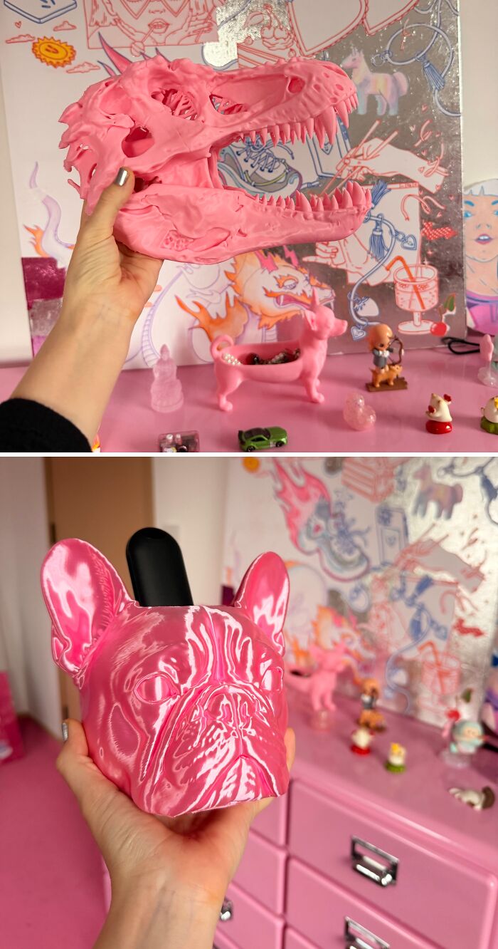 Bright pink dinosaur skull and French bulldog head display pieces from 3D prints
