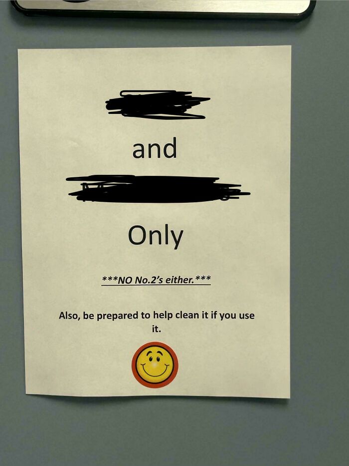 An office sign warning employees about restricted restroom use, showcasing strange aspects of modern life in America.