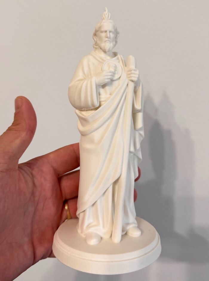 A detailed white statue of a saint created with 3D prints.