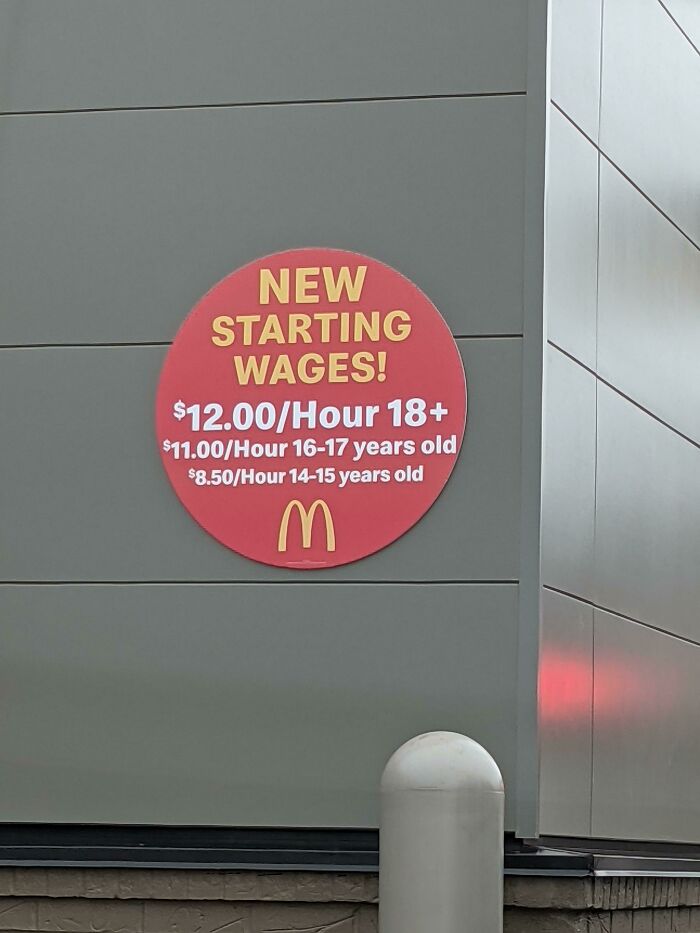 McDonalds starting wages sign showcasing different hourly pay rates, a reality of modern life in America.