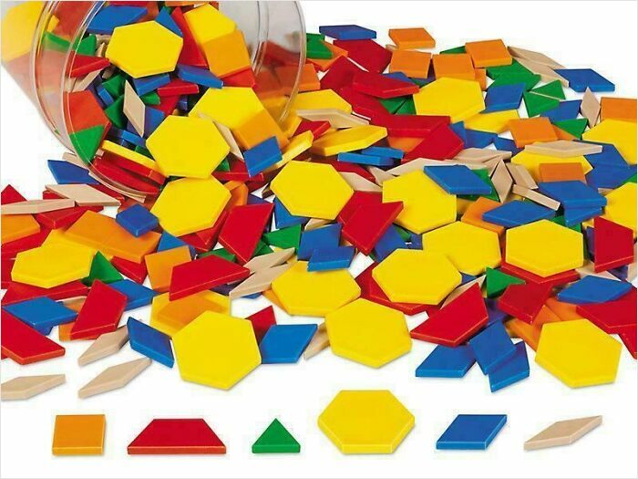 Colorful plastic pattern blocks spilled from a container, bringing back nostalgic images of school days