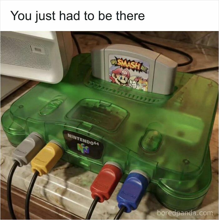 Green Nintendo 64 console with Super Smash Bros game cartridge for nostalgic 90s kids.