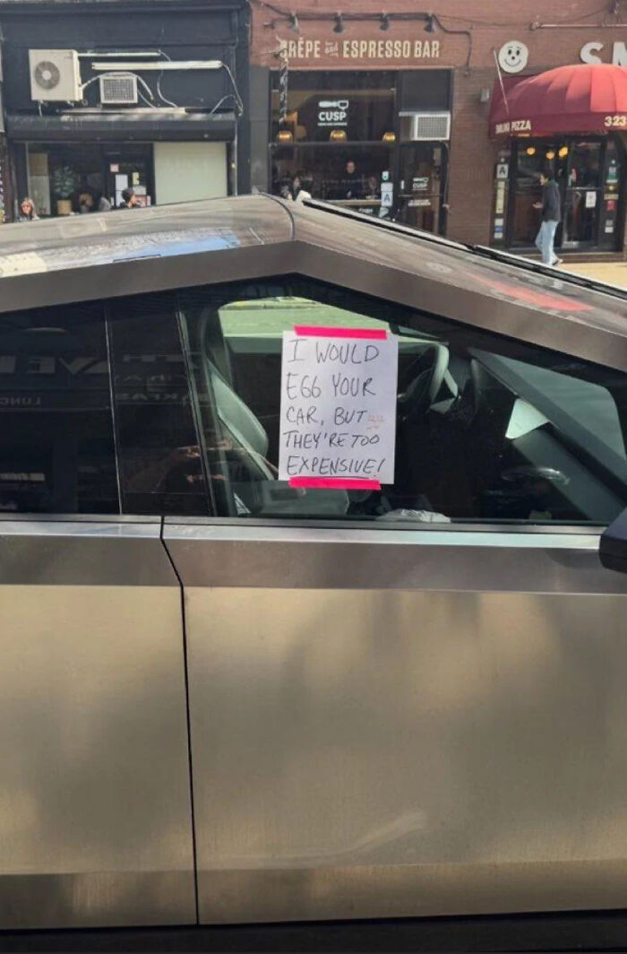 Funny public art sticker note on a car window reading I would egg your car but they are too expensive.