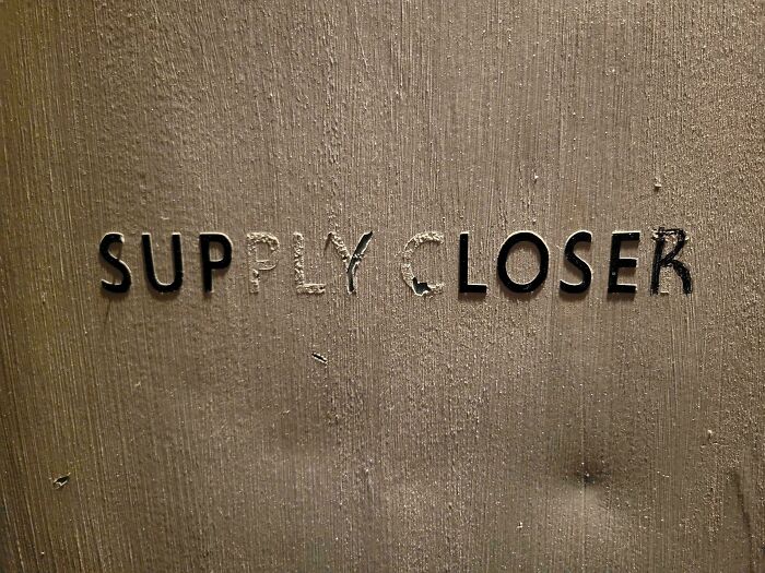 Supply Closet door sign with letters scratched out to read Supply Closer, showing subtle vandalism