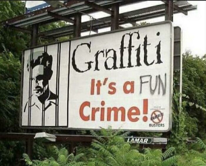 A graffiti sign vandalized with spray paint to read Graffiti is a FUN Crime instead of an ugly crime
