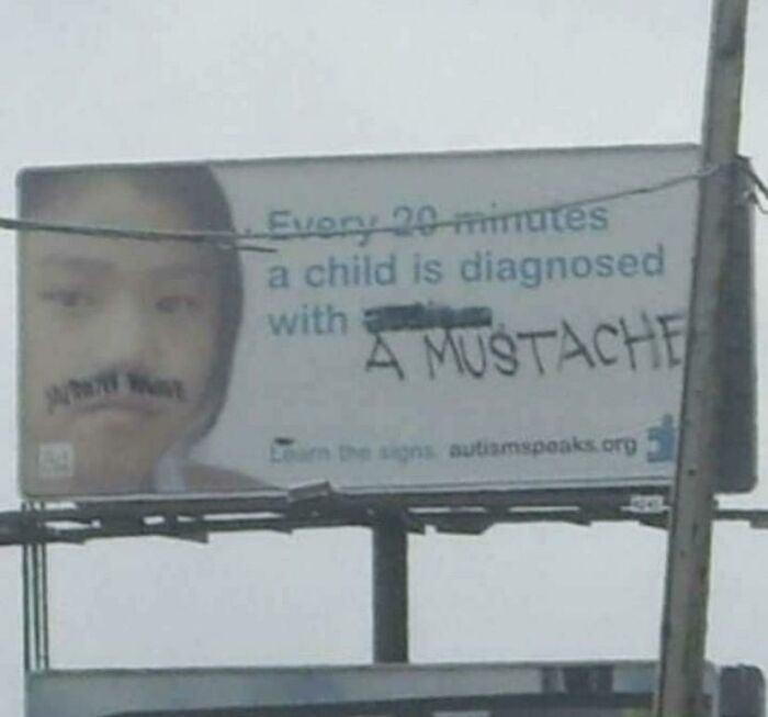 Creative act of vandalism on a public billboard altering the text to read diagnosed with a mustache