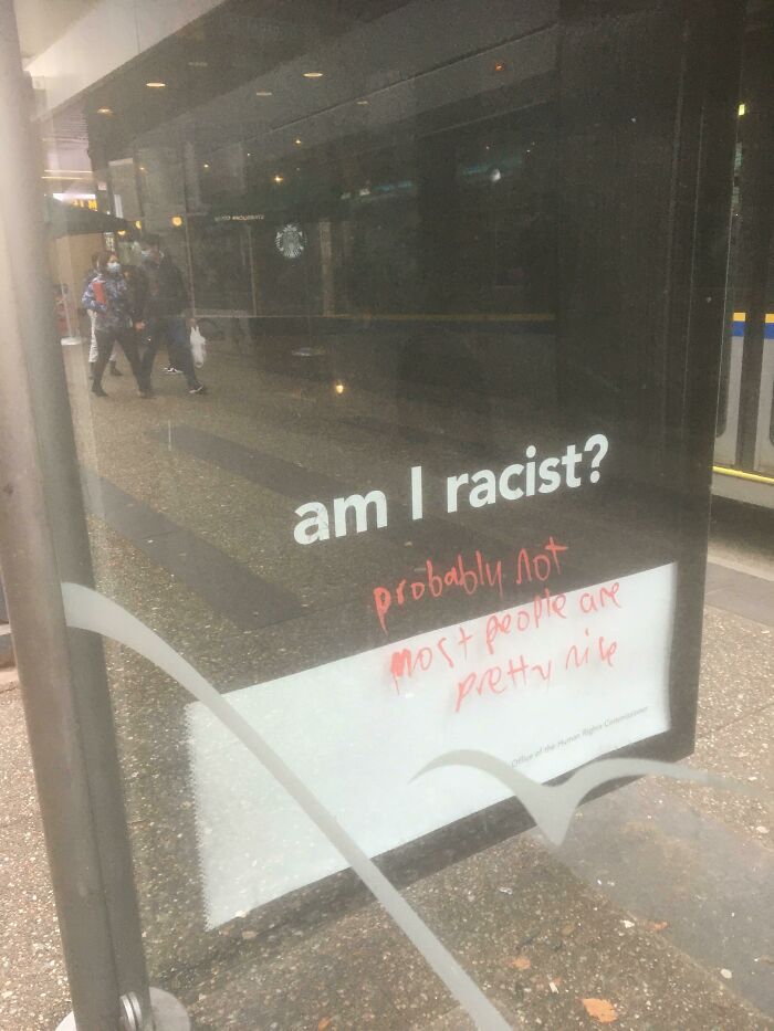 Gentle acts of vandalism with graffiti replying to a bus stop question about racism